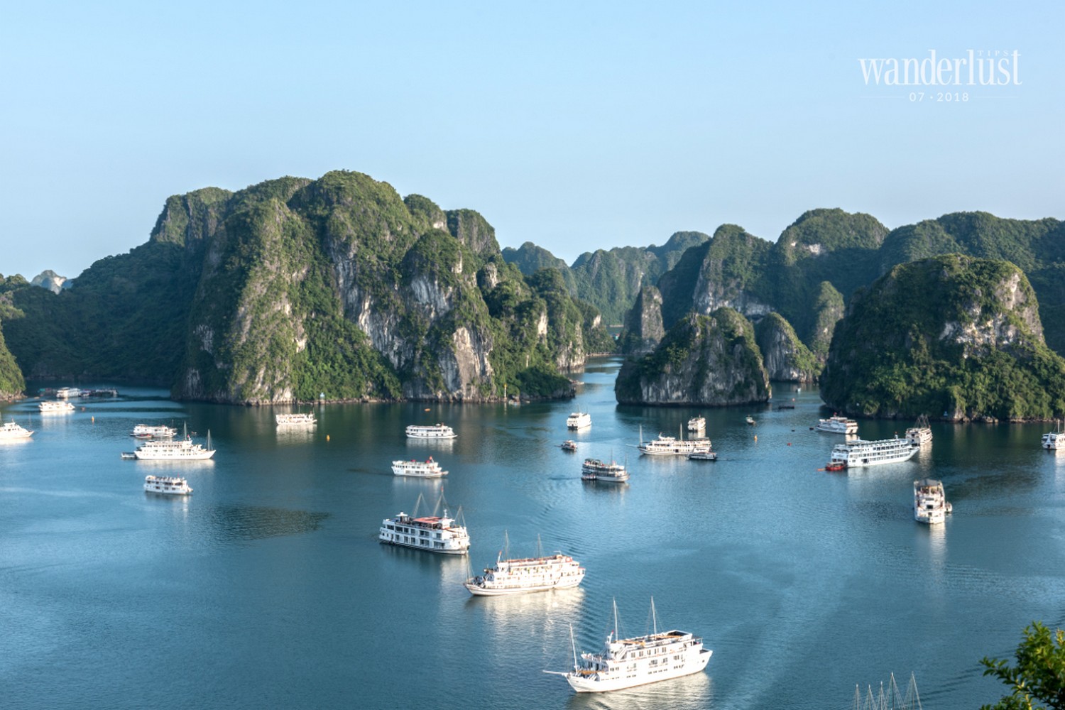 Wanderlust Tips Magazine | Admire the sunrise amidst the limestones in Ha Long Bay